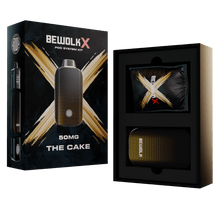 BewolKx Pod System Kit 'The Cake' 50MG shown next to its retail packaging box. The product is a dark brown vape pod system with a gold accent ring, displayed alongside its black and gold outer box and an open inner presentation box showing a matching pouch.